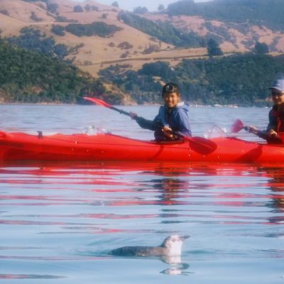 people kayaking in a red kayak
